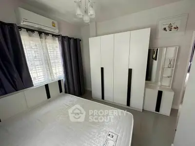 Modern bedroom with sleek wardrobe and air conditioning