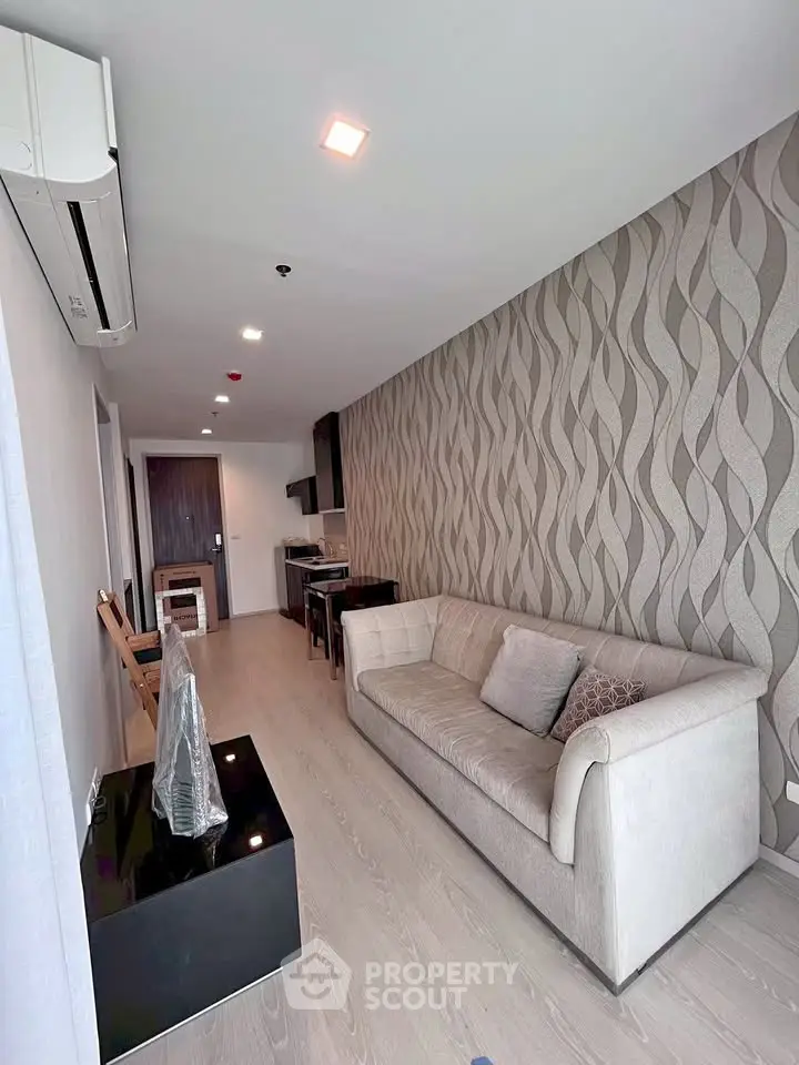 Modern living room with stylish wallpaper and cozy sofa in a contemporary apartment.