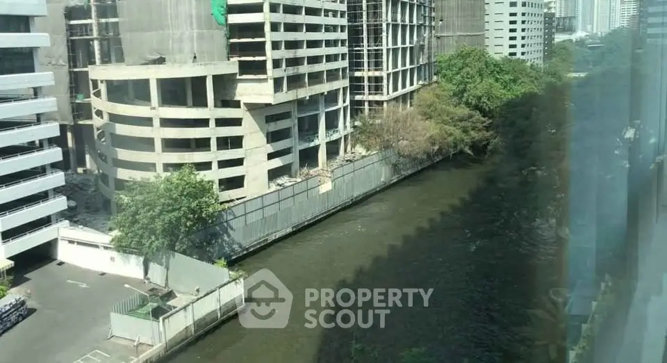 Urban river view with modern building construction in bustling cityscape