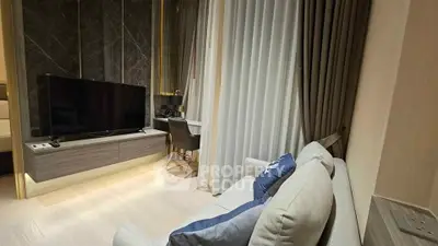 Modern living room with sleek TV setup and cozy seating area
