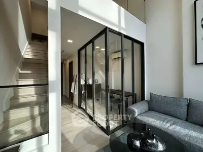 Modern living room with glass-walled study and staircase in stylish apartment