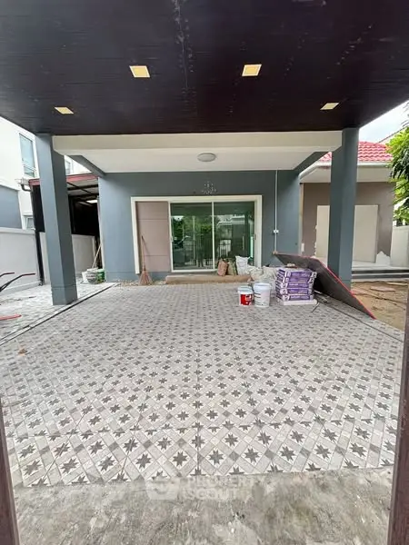 Spacious modern home entrance with tiled flooring and large glass doors