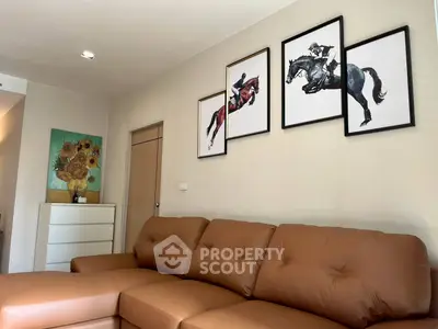 Stylish living room with brown leather sofa and equestrian art decor