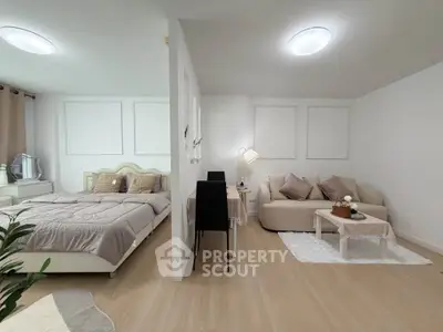 Modern studio apartment with cozy bedroom and stylish living area, perfect for urban living.