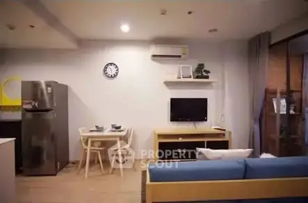 Modern living room with dining area and sleek furniture in open layout.