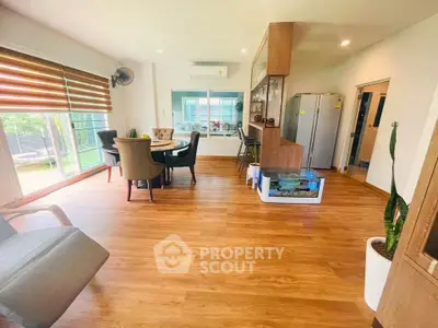 Spacious open-plan living area with modern decor and large windows