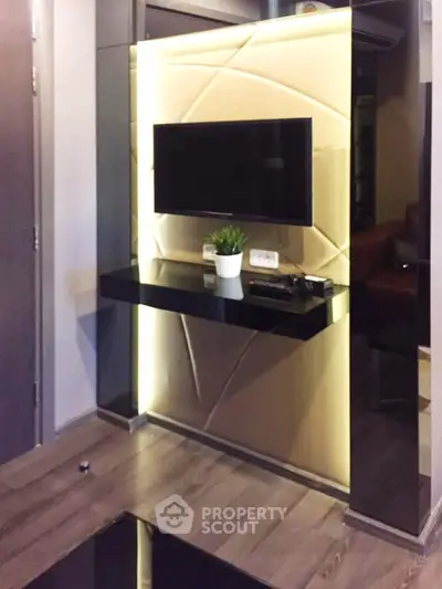 Modern living room with sleek TV setup and stylish lighting