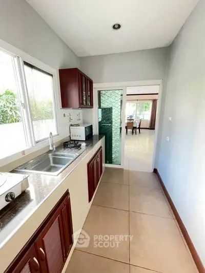 Modern kitchen with sleek design and open layout, featuring gas stove and ample natural light.