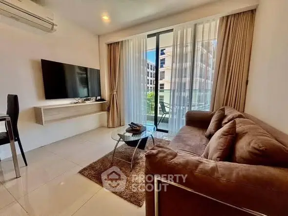 Modern living room with large TV and balcony view in luxury apartment