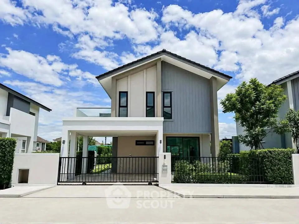 Modern two-story house with sleek design and lush greenery, perfect for family living.