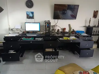 Spacious home office with modern desk and computer setup, ideal for productivity.