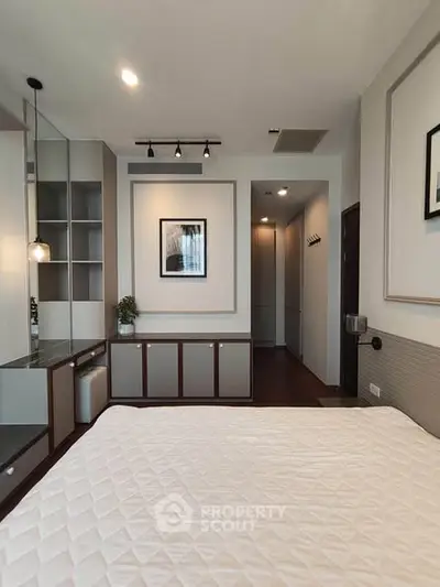 Modern bedroom with stylish decor and ample storage space
