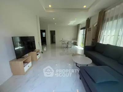 Spacious modern living room with sleek furniture and large windows