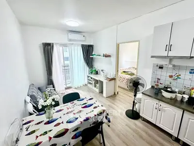Bright and cozy apartment with open living and dining area, featuring modern decor and natural light.