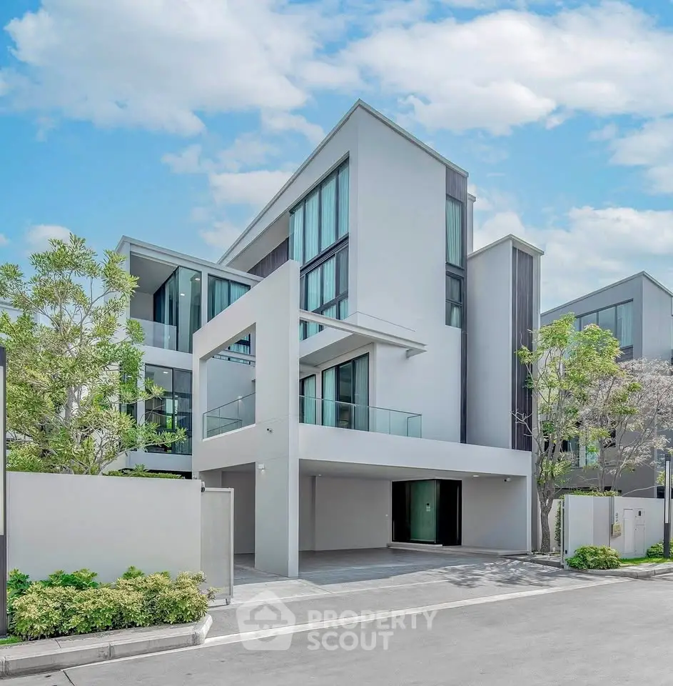 Modern luxury townhouse with sleek design and large windows in a serene neighborhood.
