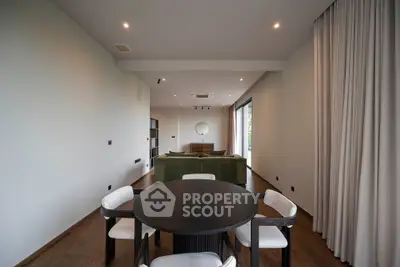 Spacious modern living room with elegant dining area and large windows