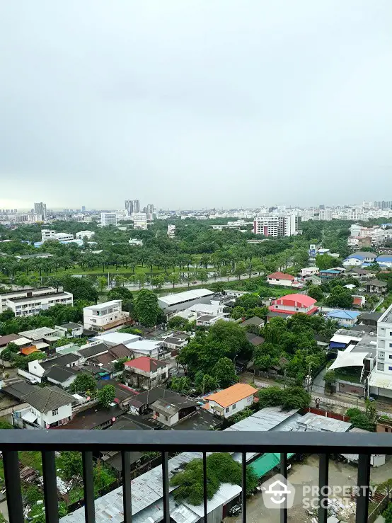 High-rise balcony view showcasing a panoramic urban landscape with lush greenery, offering a serene escape amidst the bustling city life.