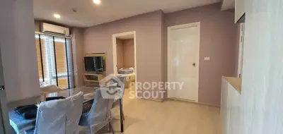 Modern apartment interior with dining area and view into bedroom