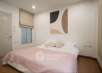 Cozy bedroom with modern decor and soft lighting, perfect for relaxation.