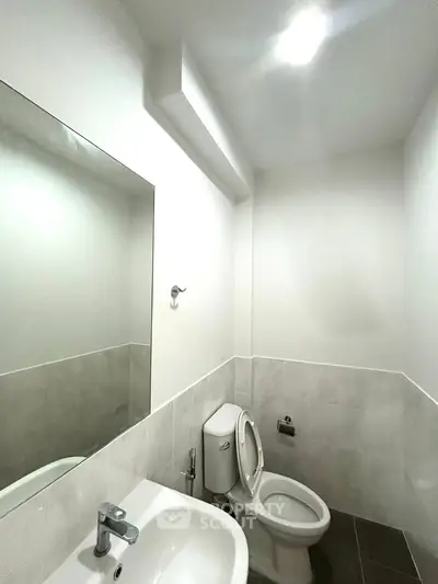 Modern minimalist bathroom with sleek fixtures and bright lighting