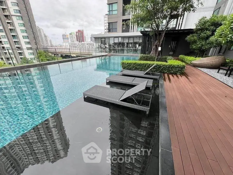Luxurious rooftop pool with city views and modern design in urban high-rise building.