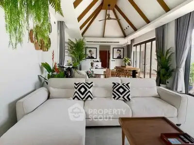 Luxurious open-plan living room with modern decor and abundant natural light