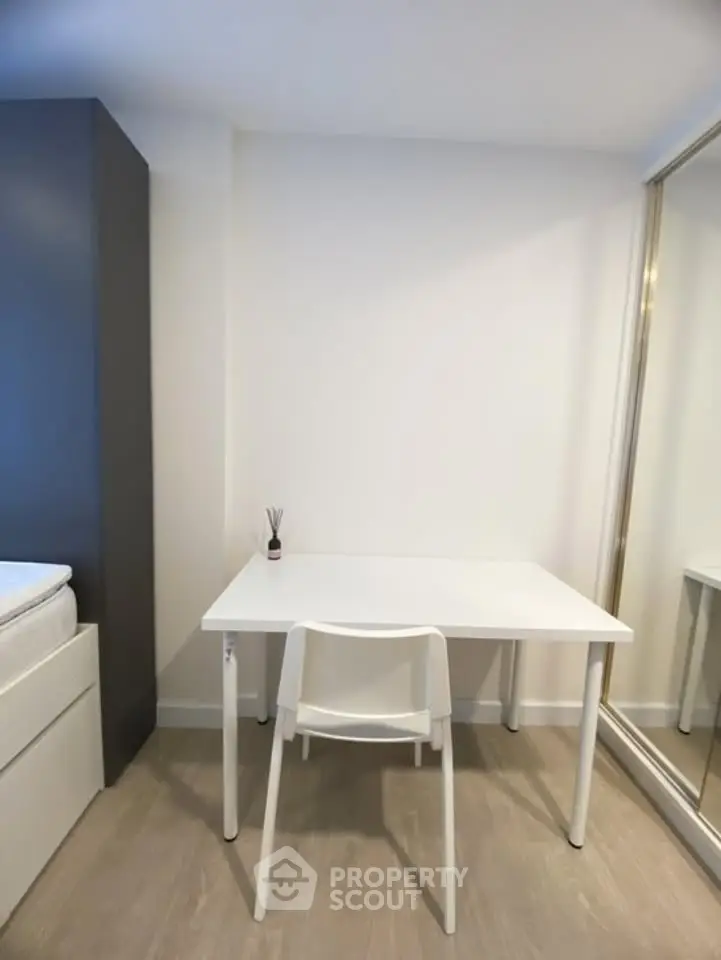 Modern minimalist study area with white desk and chair, ideal for productivity and focus.