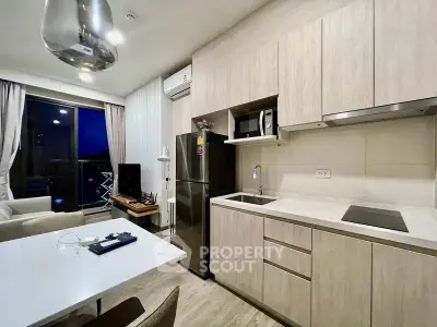 Modern kitchen with sleek cabinetry and integrated appliances in a stylish apartment.