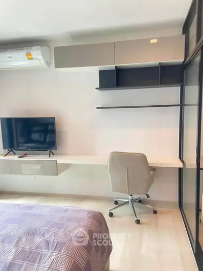 Modern bedroom with sleek desk, wall-mounted TV, and stylish shelving.