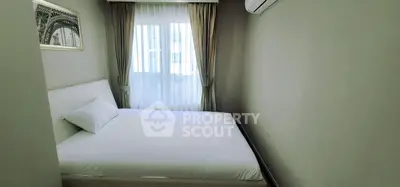 Cozy bedroom with a large window and air conditioning, perfect for relaxation and comfort.