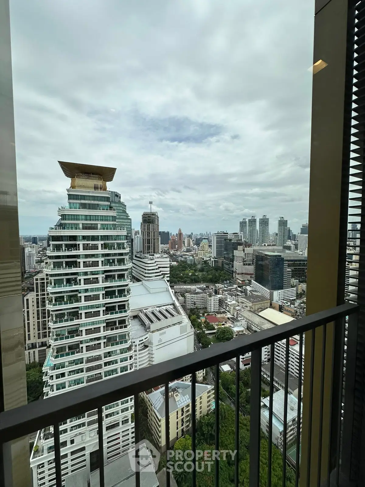 Stunning cityscape view from high-rise balcony with modern architecture.