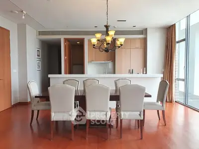 Spacious dining area with elegant chandelier and open kitchen layout.