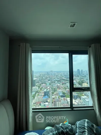 Stunning cityscape view from a high-rise apartment window, showcasing urban living at its finest.