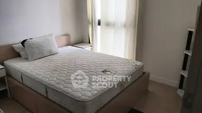 Cozy bedroom with natural light and modern furnishings, perfect for relaxation and comfort.