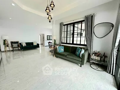 Spacious living room with modern decor and large windows