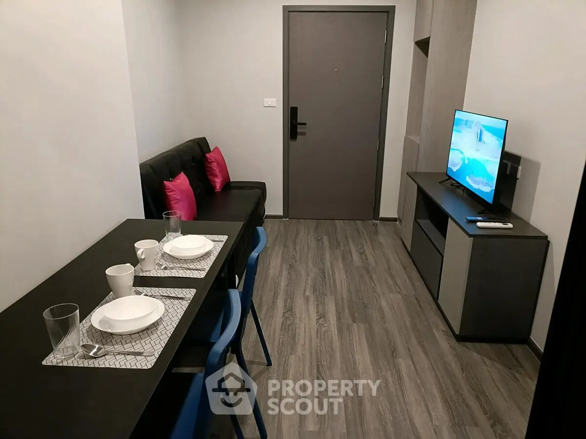 Modern living room with sleek furniture and TV setup, perfect for cozy urban living.