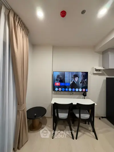 Modern living room with TV and dining area in stylish apartment