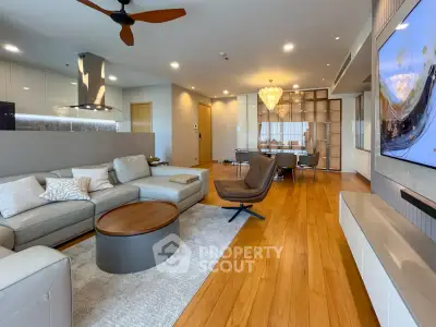 Spacious modern living room with elegant decor and open layout, featuring hardwood floors and stylish furniture.