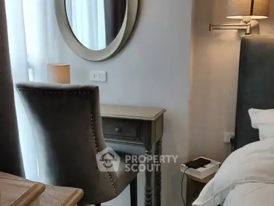 Elegant bedroom corner with stylish chair and mirror, perfect for a cozy reading nook.