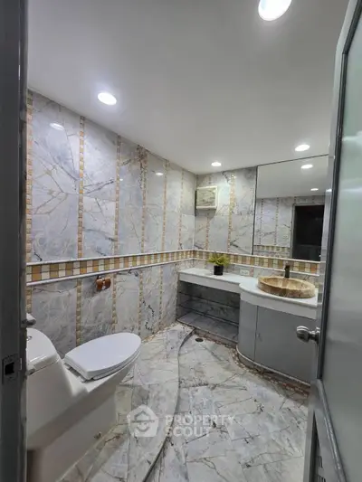 Luxurious marble bathroom with elegant fixtures and modern lighting