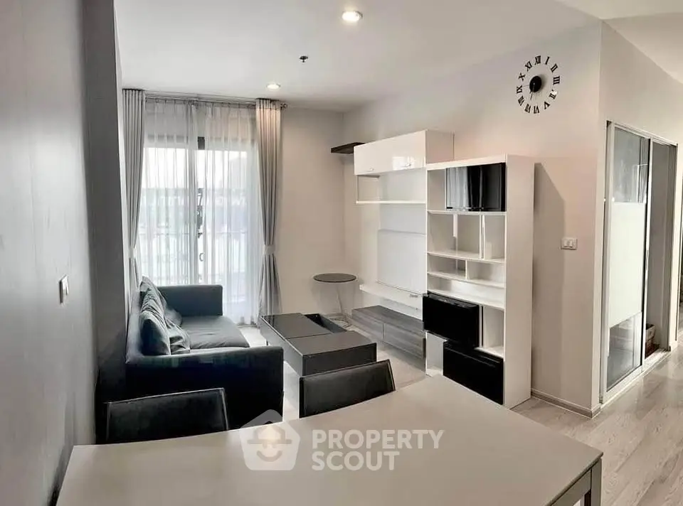 Modern living room with sleek furniture and natural light, perfect for urban living.