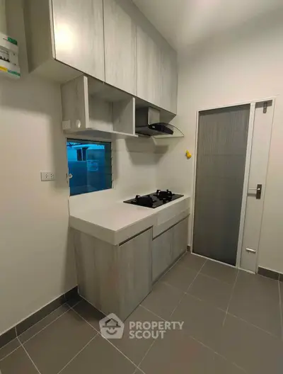 Modern kitchen with sleek cabinets and gas stove in a compact layout