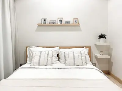 Cozy minimalist bedroom with stylish decor and soft lighting, perfect for relaxation.