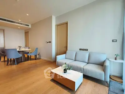 Modern living room with elegant dining area and cozy sofa