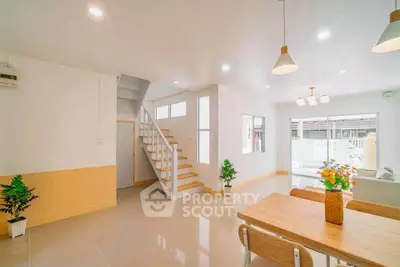 Bright modern living room with open layout and stylish staircase