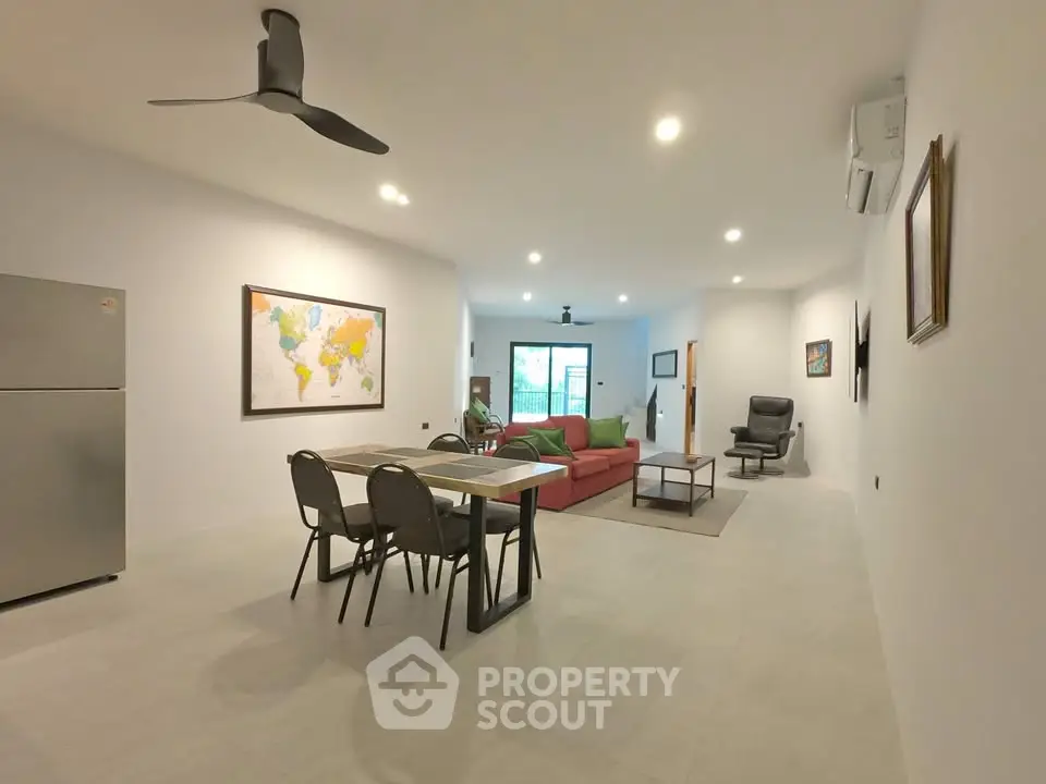 Spacious modern living room with stylish furniture and open layout, perfect for family gatherings.