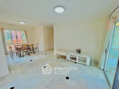 Spacious living room with dining area and natural light