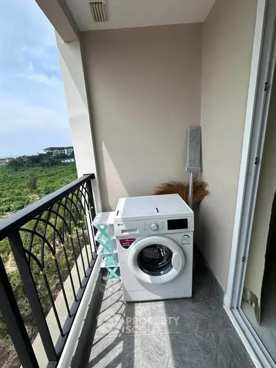 Charming balcony with washing machine and scenic view, perfect for urban living.