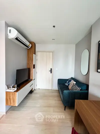 Modern living room with sleek furniture and wall-mounted TV in a stylish apartment.