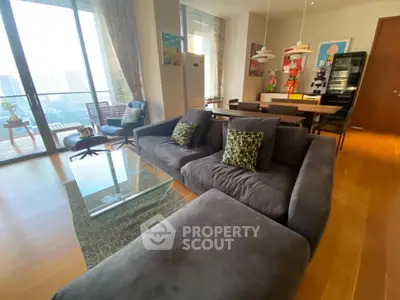 Spacious living room with modern decor and balcony view in luxury apartment.